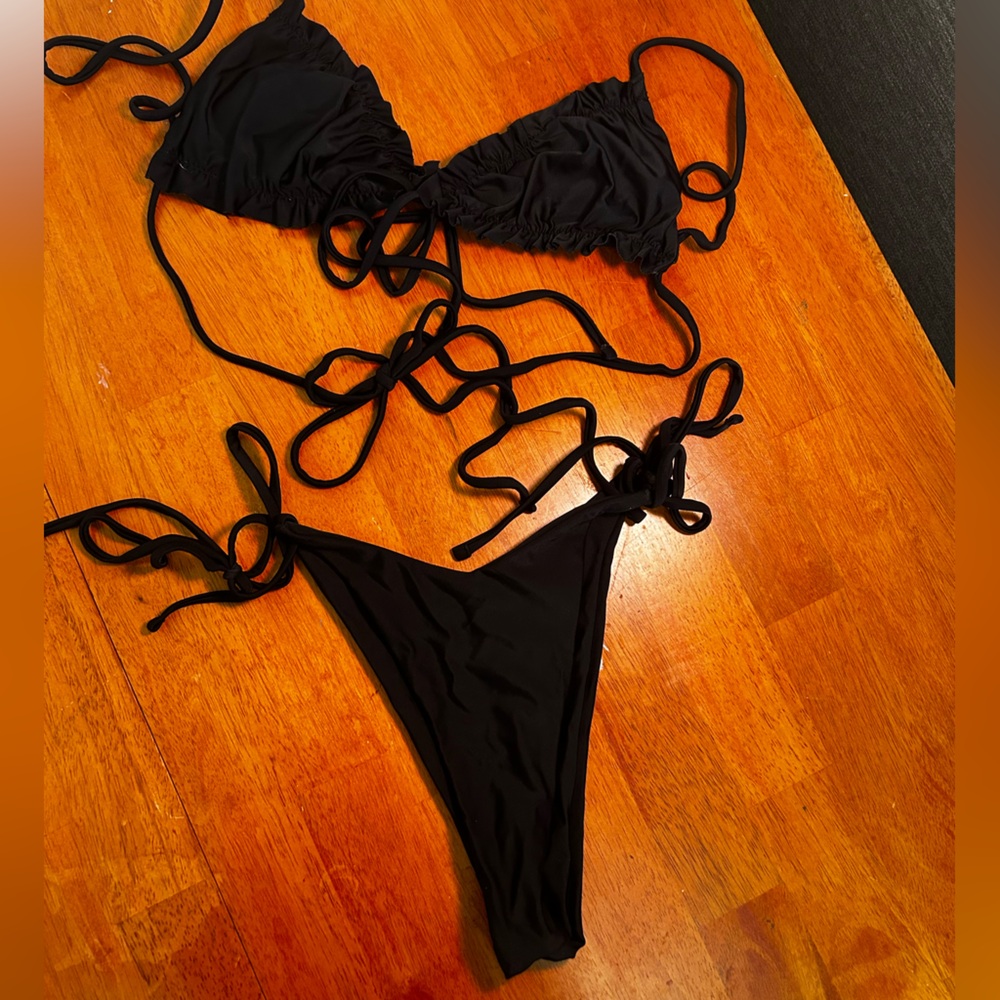 Black string bikini, ruffled top and plain bottoms